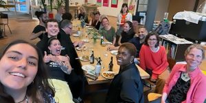Shantel Watson (centre seated) with staff and volunteers from the zusammenleben community group.
